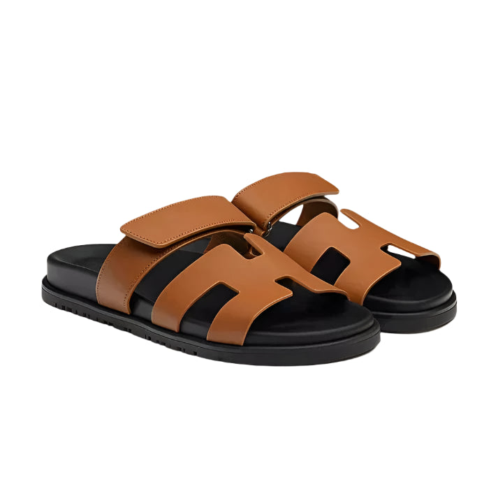 Sandals with exposed upper and flat outsole, displayed flat