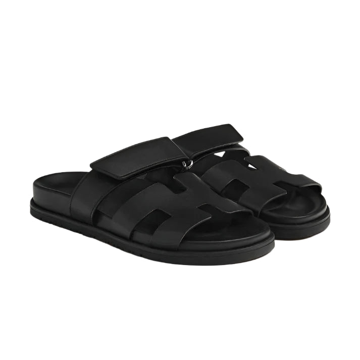 Flat sandals with open strap design and straight sole, laid flat