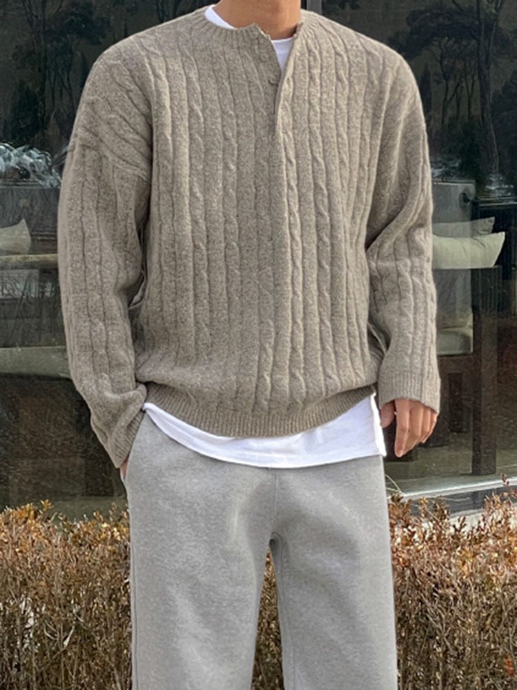 Henley sweater with button collar, ribbed sleeves, and knit texture