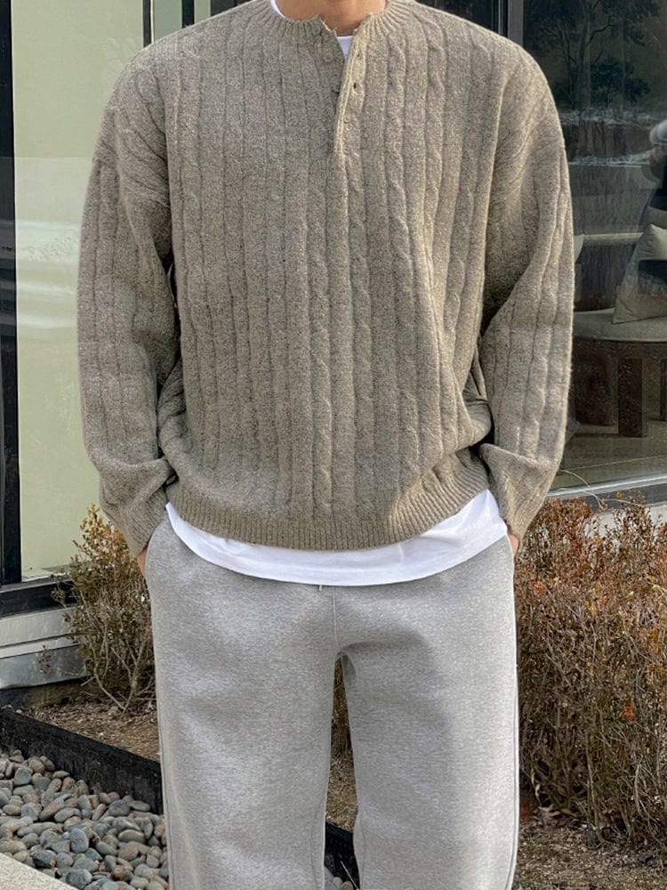 Henley sweater with button collar, ribbed sleeves, and knit texture