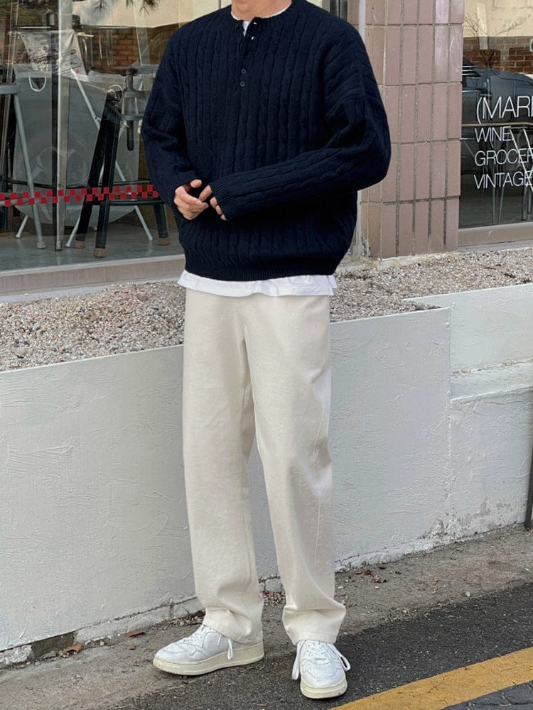 Henley sweater with button collar, ribbed sleeves, and knit texture