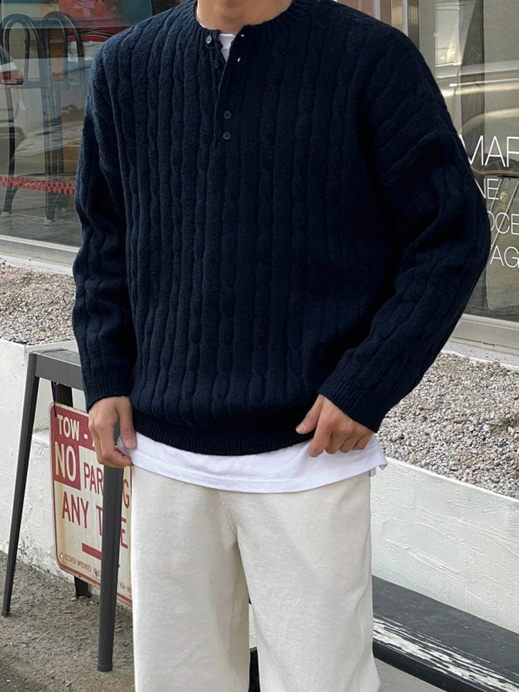 Henley sweater with button collar, ribbed sleeves, and knit texture