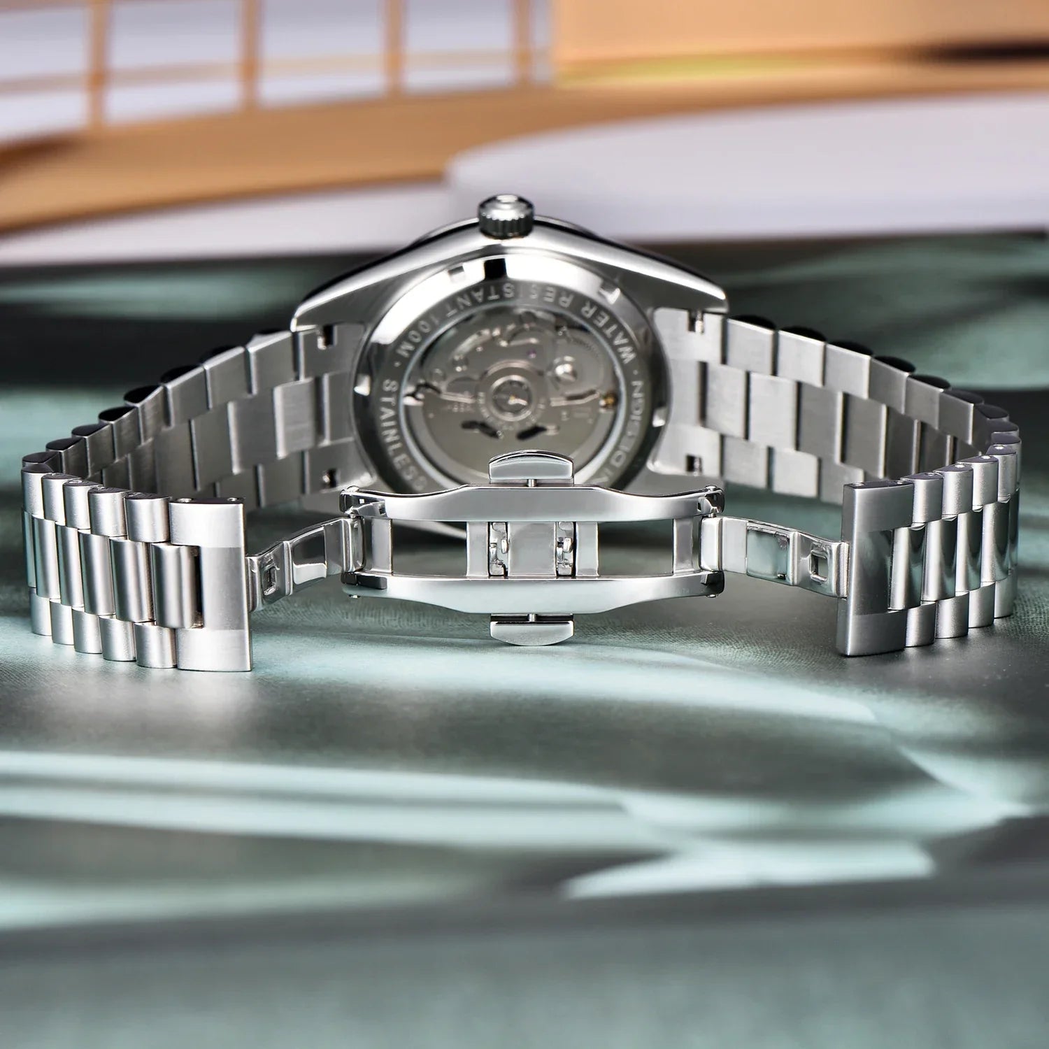 Flat-lay of chain strap watch with bold markers and case crown