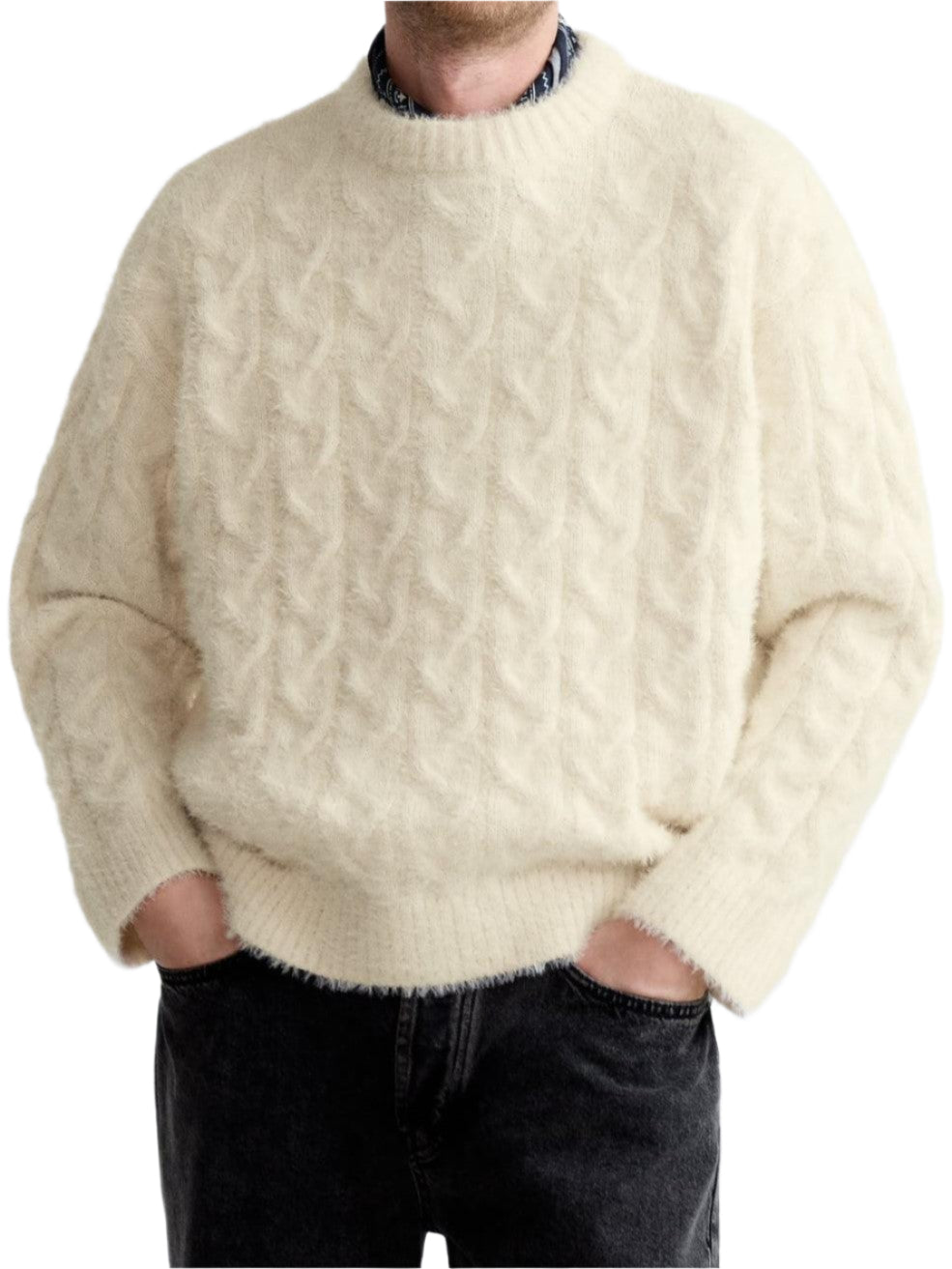 Model wearing cable knit sweater with round neckline and ribbed hem
