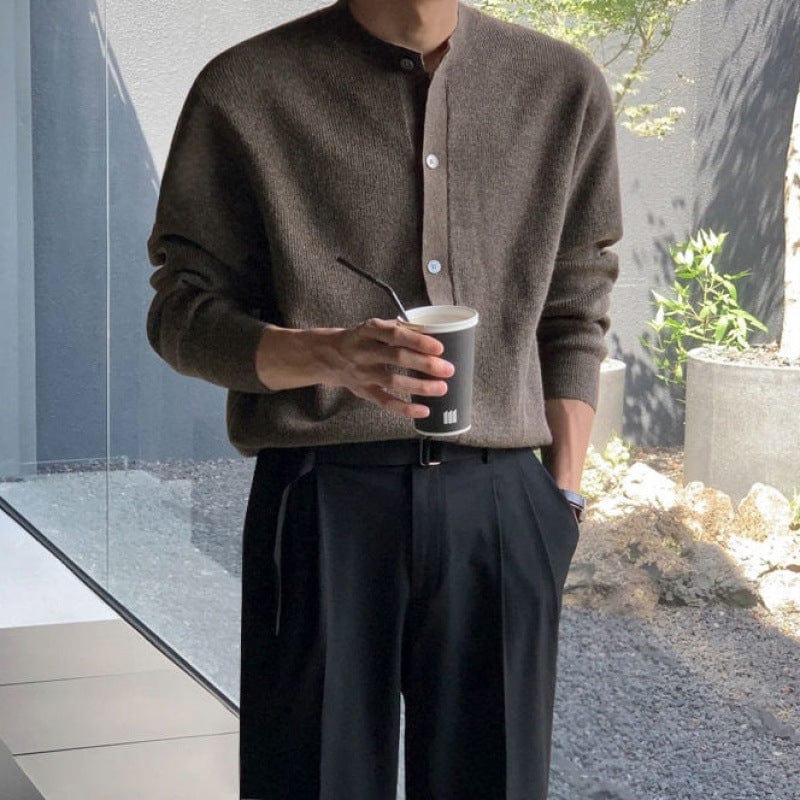 Men’s cardigan with circular neckline, ribbed hem, and long sleeves, worn by model