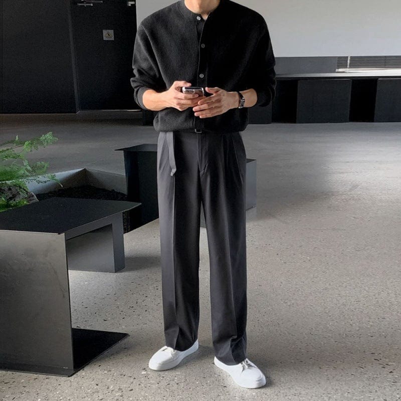 Men’s cardigan with circular neckline, ribbed hem, and long sleeves, worn by model
