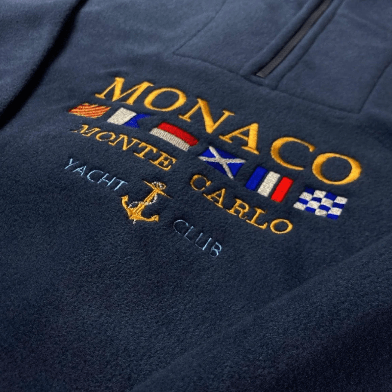 Men’s half zip sweater with embroidered motif, long sleeves, and straight hem, laid flat