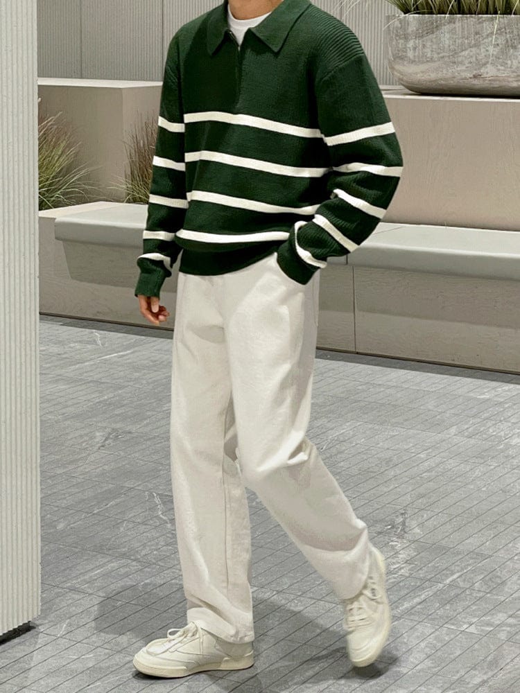 Men’s half zip sweater with ribbed hem, high collar, and long sleeves, worn by model