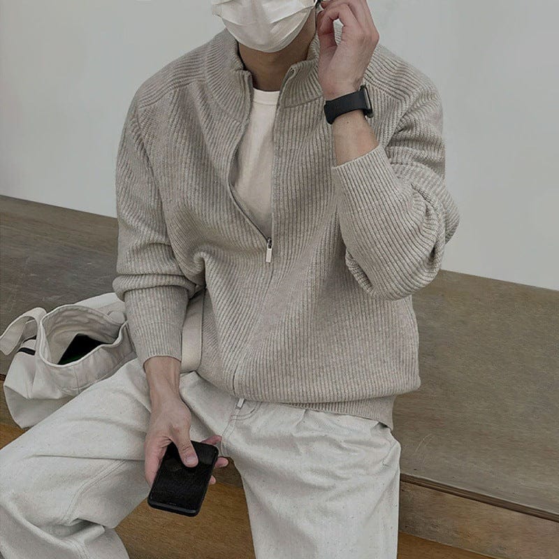 Men’s half zip sweater with stand collar, ribbed edges, and long sleeves, worn by model