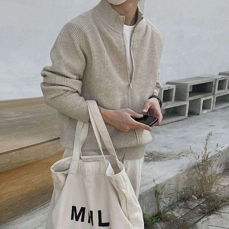 Men’s half zip sweater with stand collar, ribbed edges, and long sleeves, worn by model