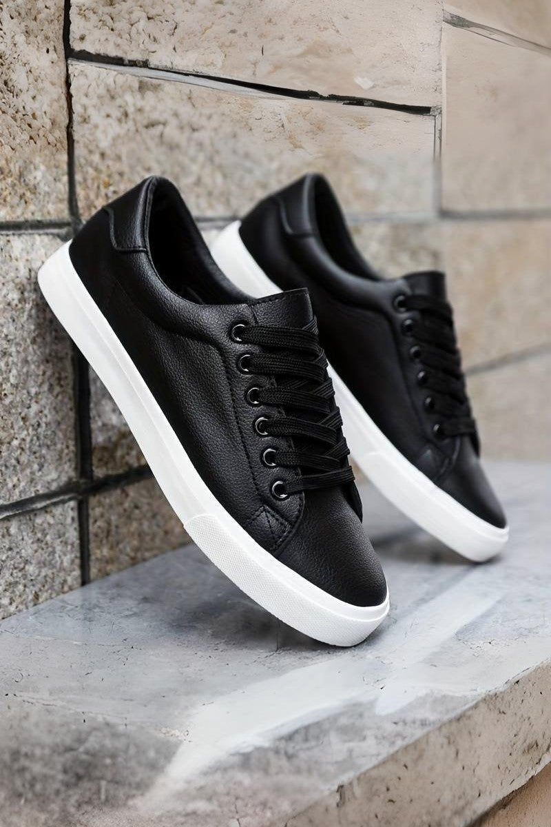Lace-up sneakers with round toe, textured outsole, and low-top design