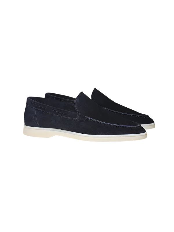 Slip-on shoes with visible stitching and rounded front, laid flat on surface