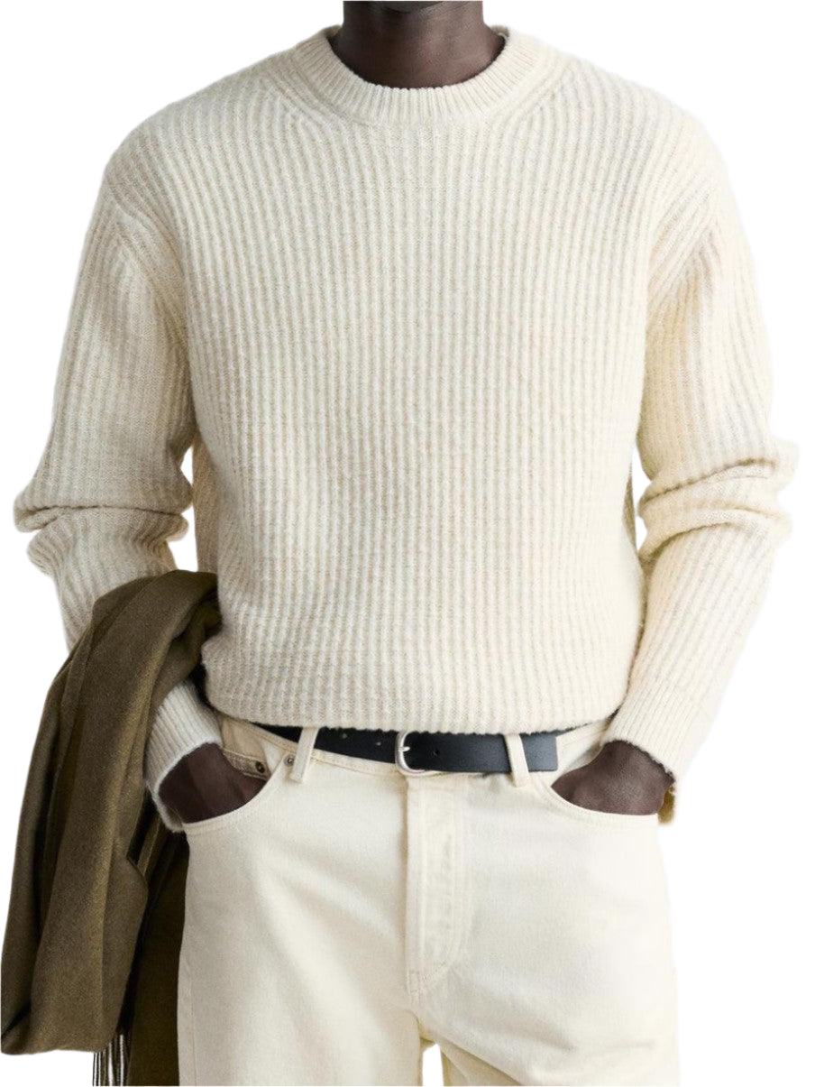 Ribbed knit sweater with straight hem and round neck, shown on model