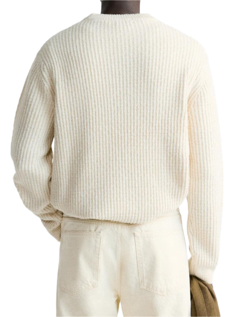 Model wearing ribbed sweater with long sleeves and crew neckline
