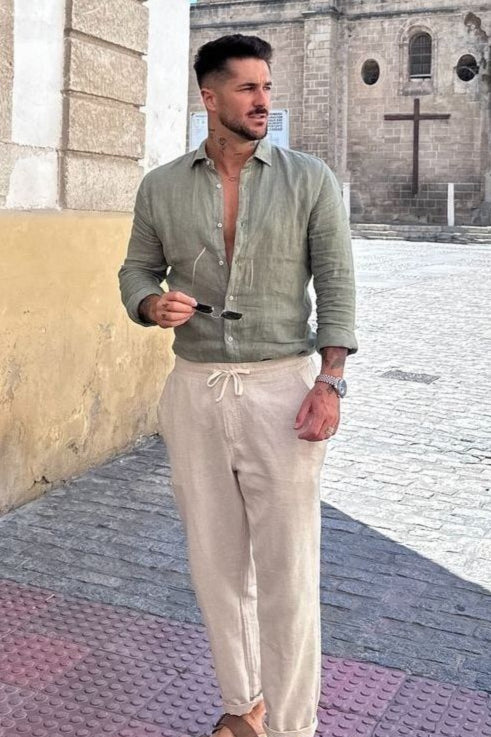 Model wearing two-piece shirt and trouser set with collar and buttoned shirt front