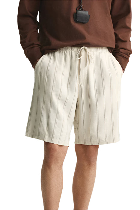 Model in above-the-knee shorts with clean front and visible seams
