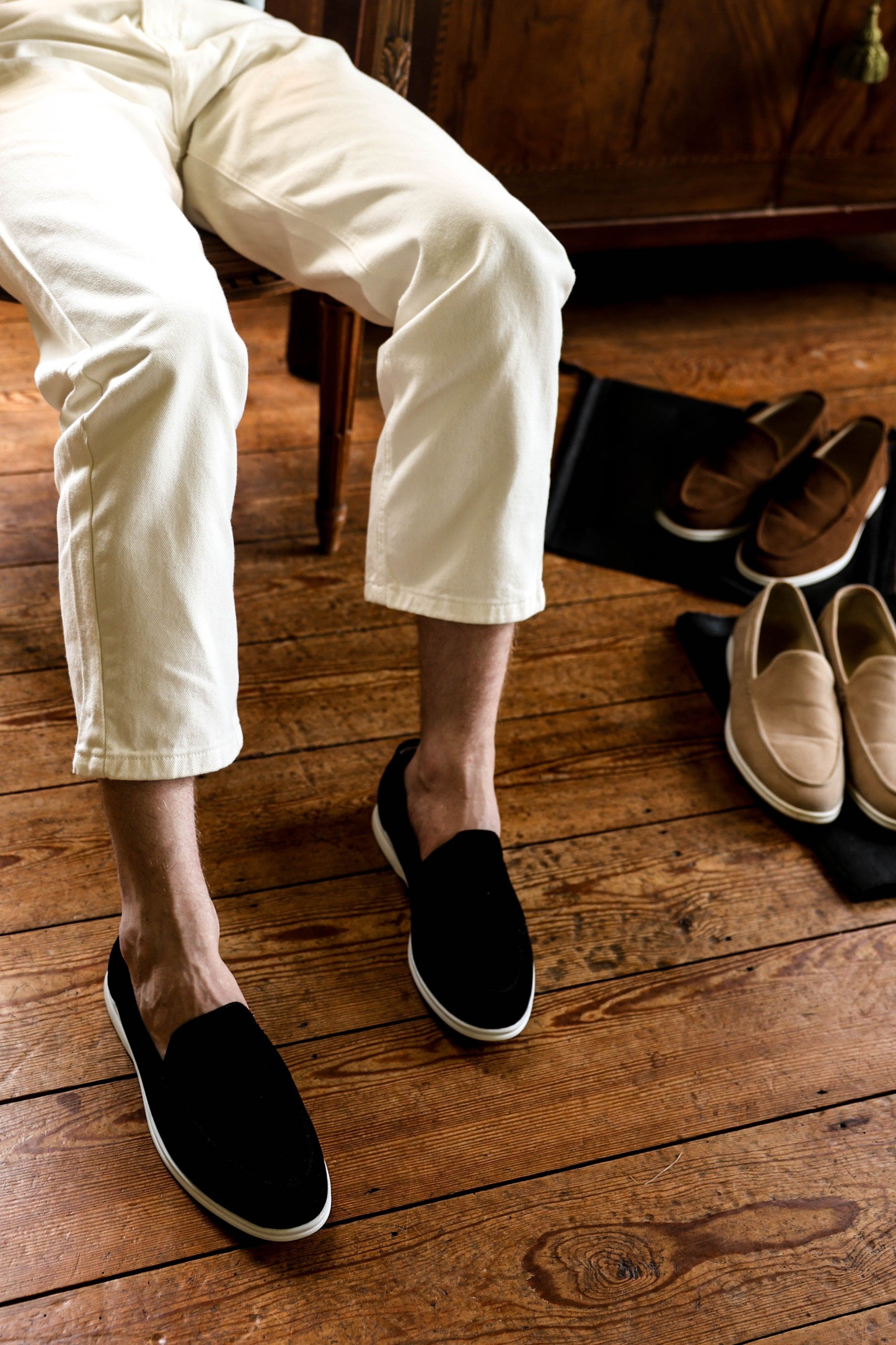 Model wearing slip-on loafers with rounded toe and flat sole