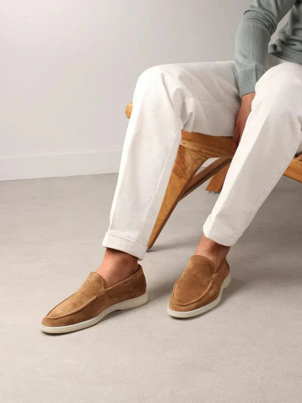Model wearing slip-on loafers with rounded toe and flat sole