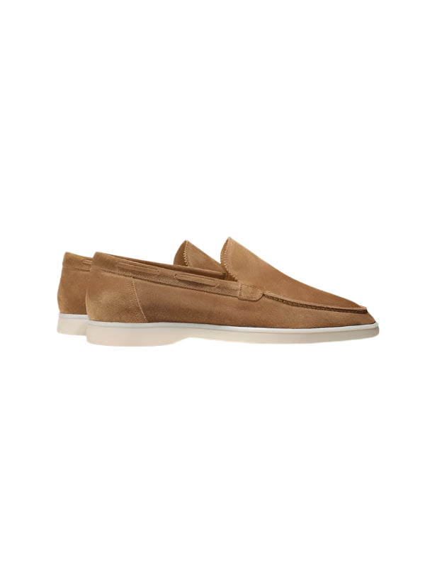 Men’s loafers with rounded toe and flat base, laid flat on surface