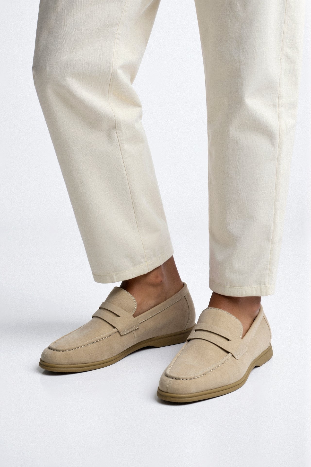 Loafers with stitched vamp and smooth upper, worn by model