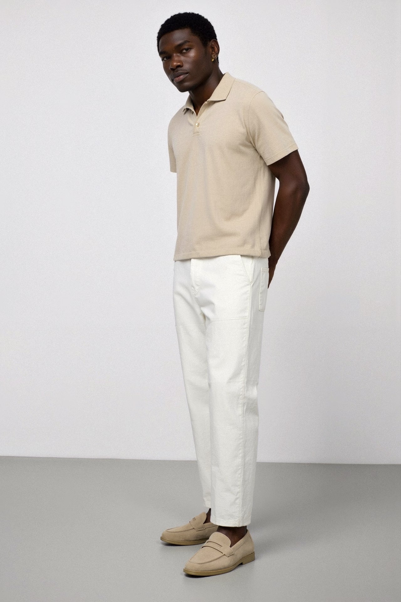 Model wearing slip-on loafers with round toe and low heel