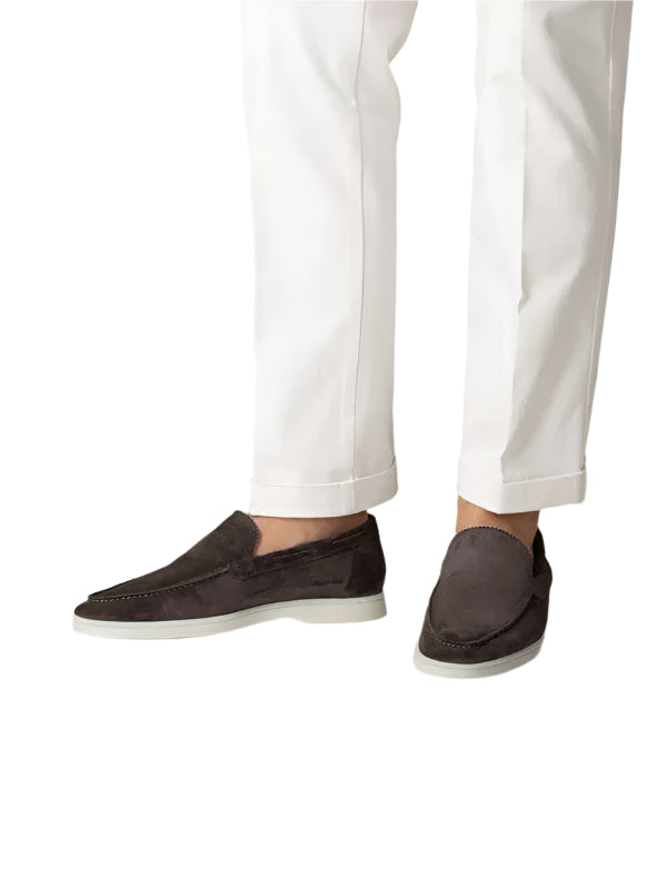 Model wearing slip-on loafers with rounded toe and flat sole