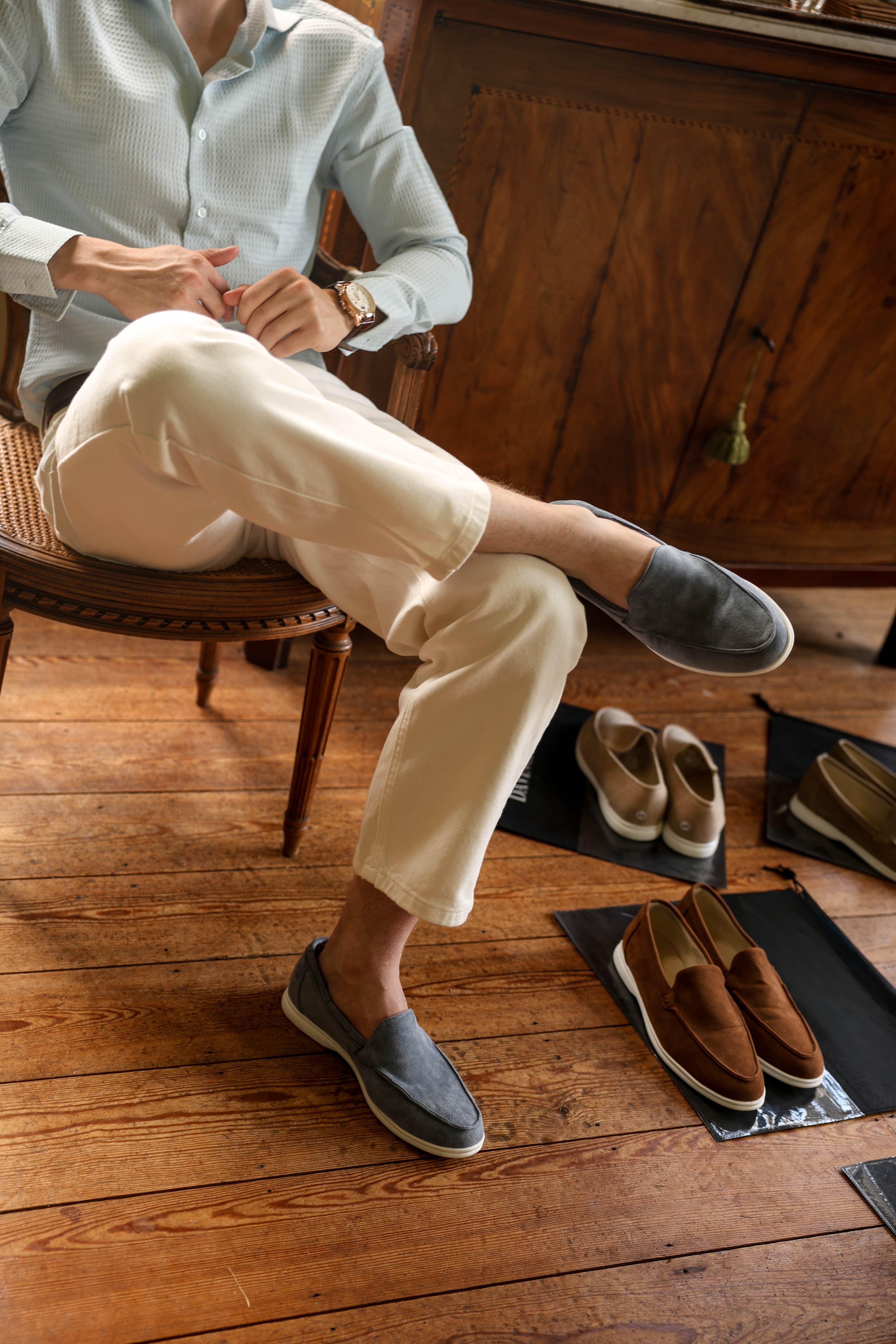 Model wearing slip-on loafers with rounded toe and rubber sole