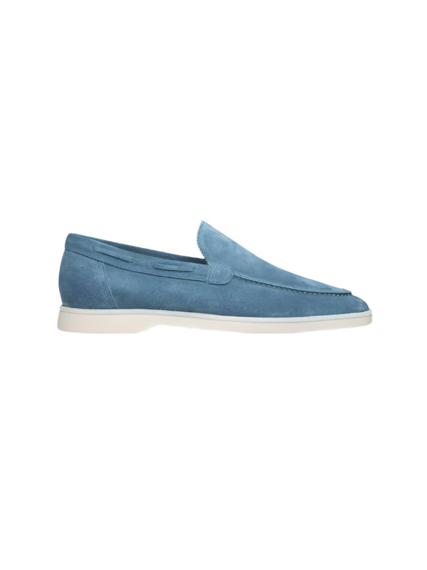 Men’s loafers with visible seams and low-cut opening, laid flat on surface