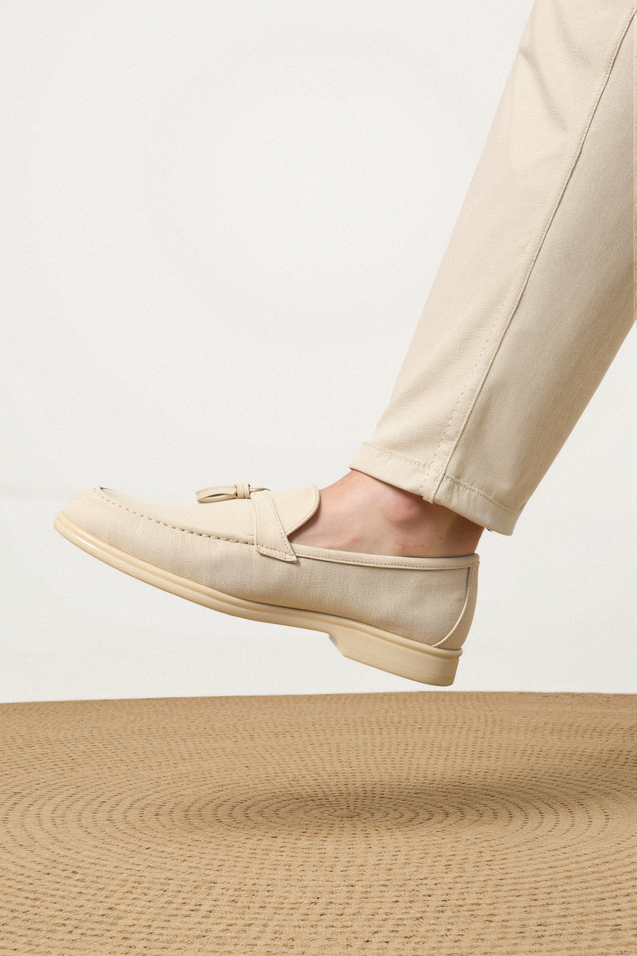 Slip-on loafers styled with tailored pants on model