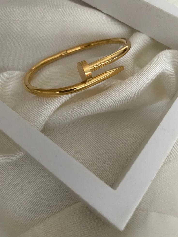 Flat-lay of men’s bracelet with nail-like structure and visible curve