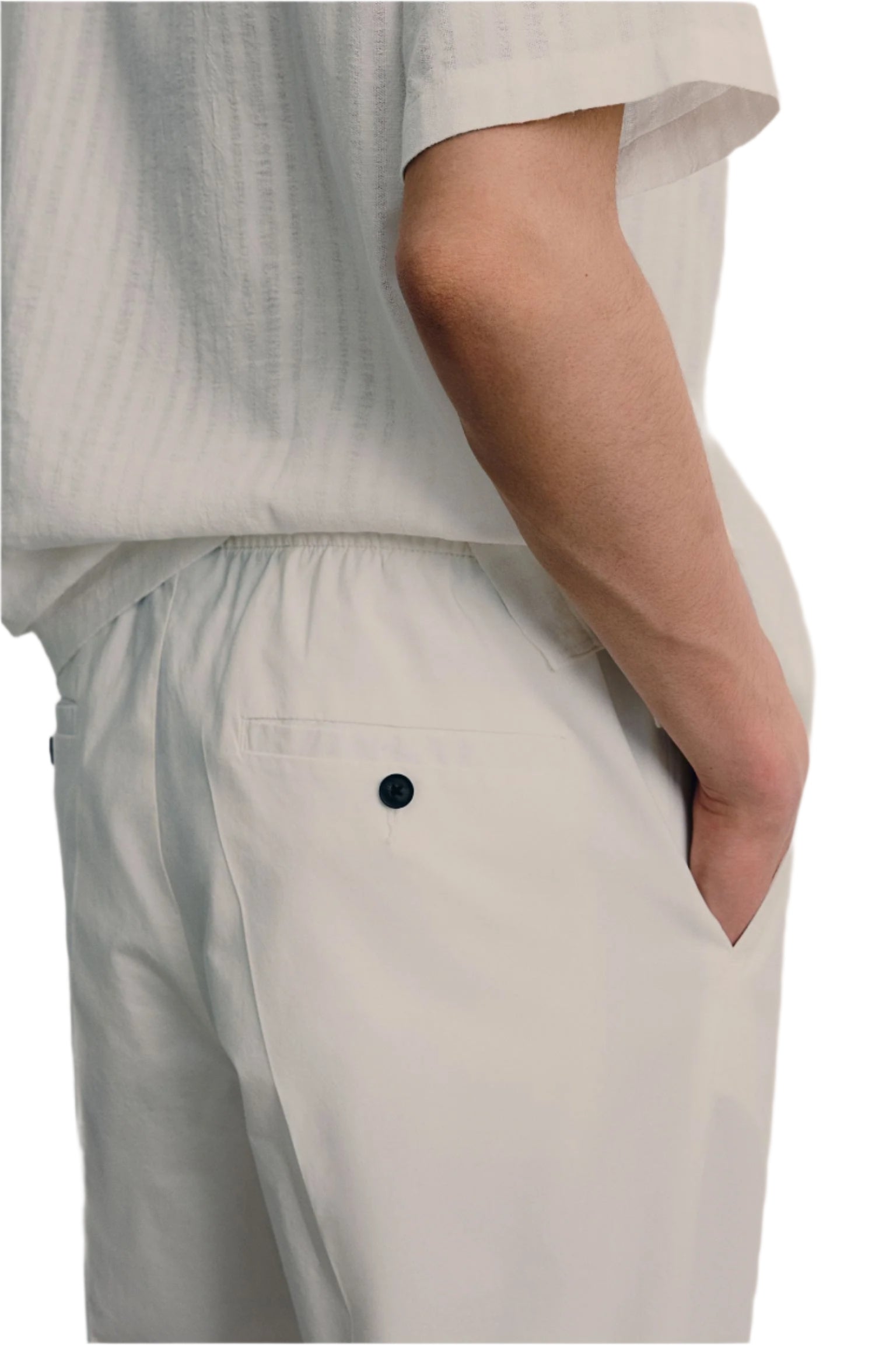 Model wearing tapered pants with side pockets and flat waistband