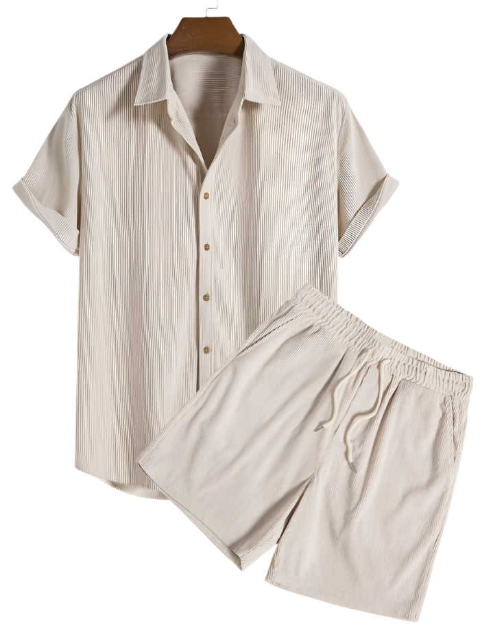 Two-piece outfit with short sleeves and relaxed leg shorts, laid flat
