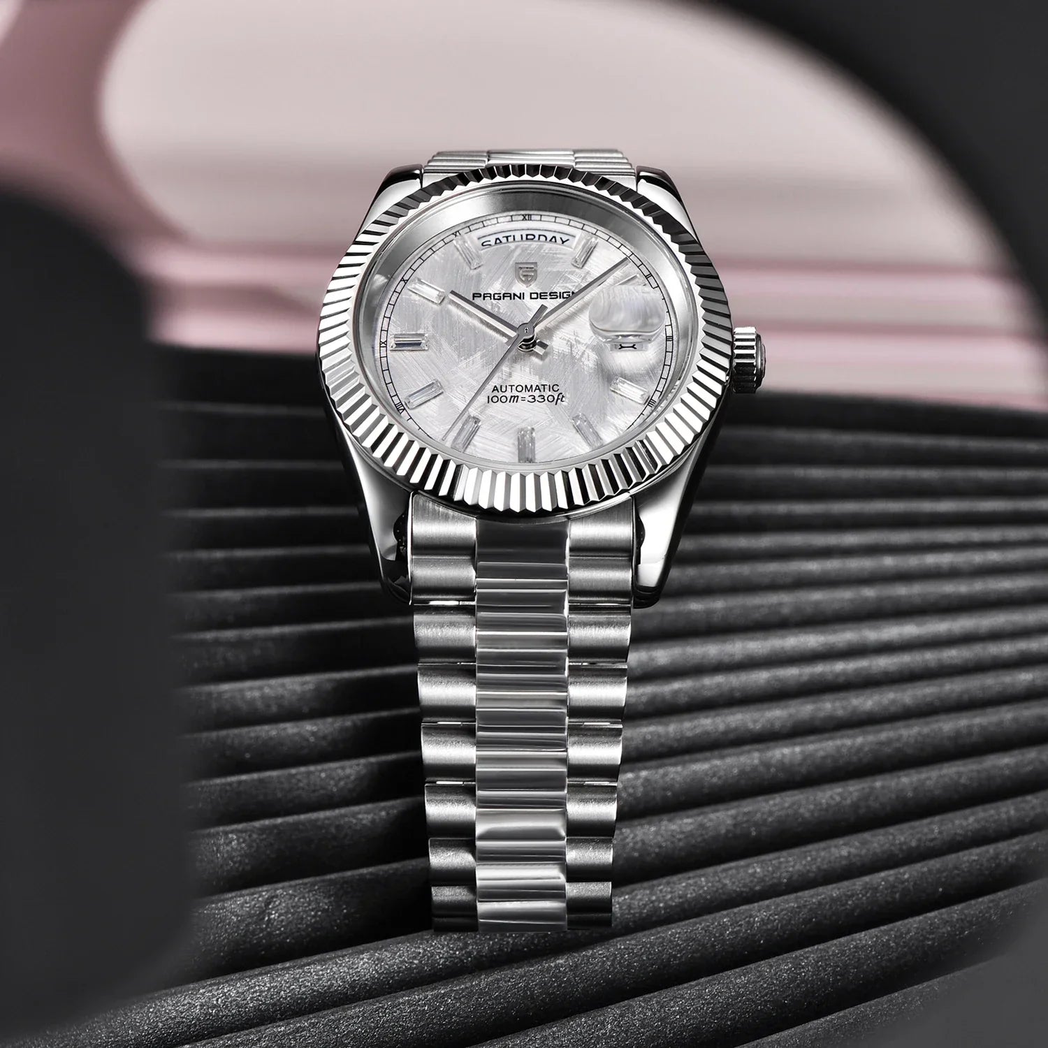 Men’s timepiece with segmented chain strap and clear dial, laid flat