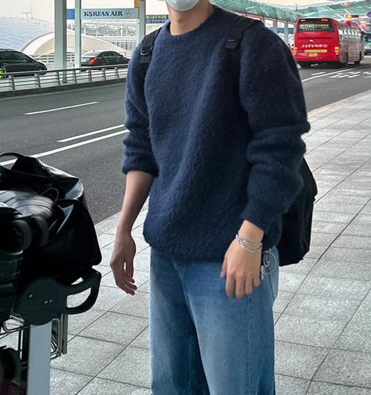 Wool blend sweater with ribbed cuffs and long sleeves, worn by  model